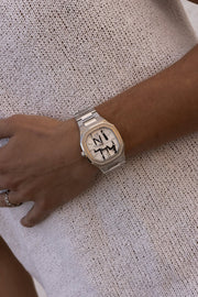 Watch on a wrist against a knit sweater