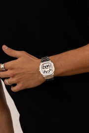 Watch on a wrist against a black top