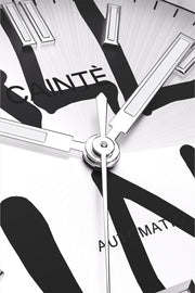 Macro view of the white dial with black graffiti lettering and polished hands