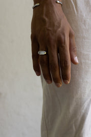 Hand at rest wearing the white inlay signet ring