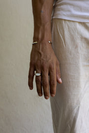 Man in linen trousers wearing the inlay signet ring