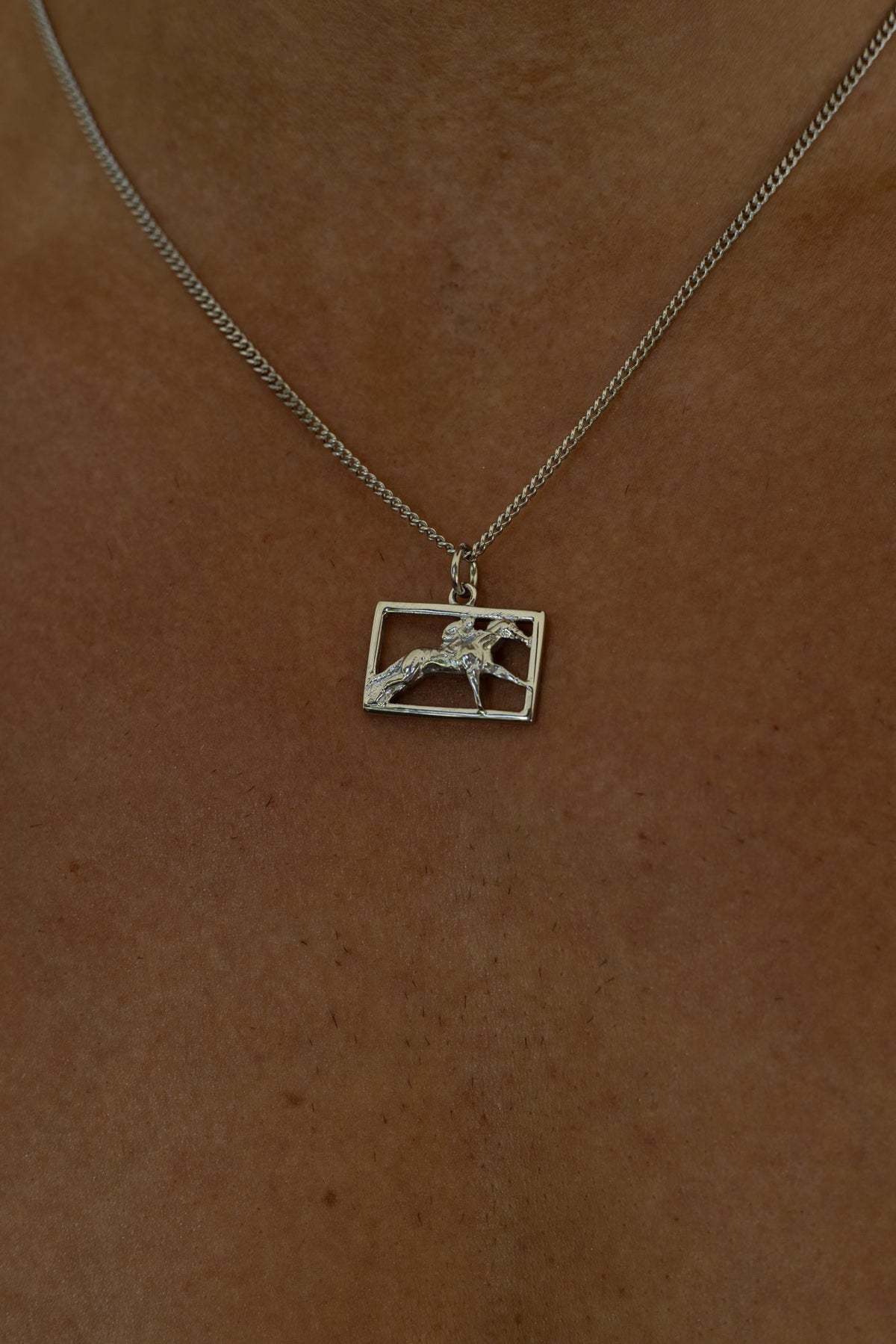 Silver-tone necklace with a rectangular horse and rider plaque, view 7 of 8