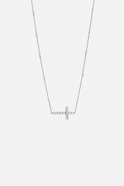 Silver-tone sideways cross necklace, front view on a light background