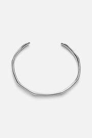 Silver-tone slim wavy cuff bracelet, front view on a light background