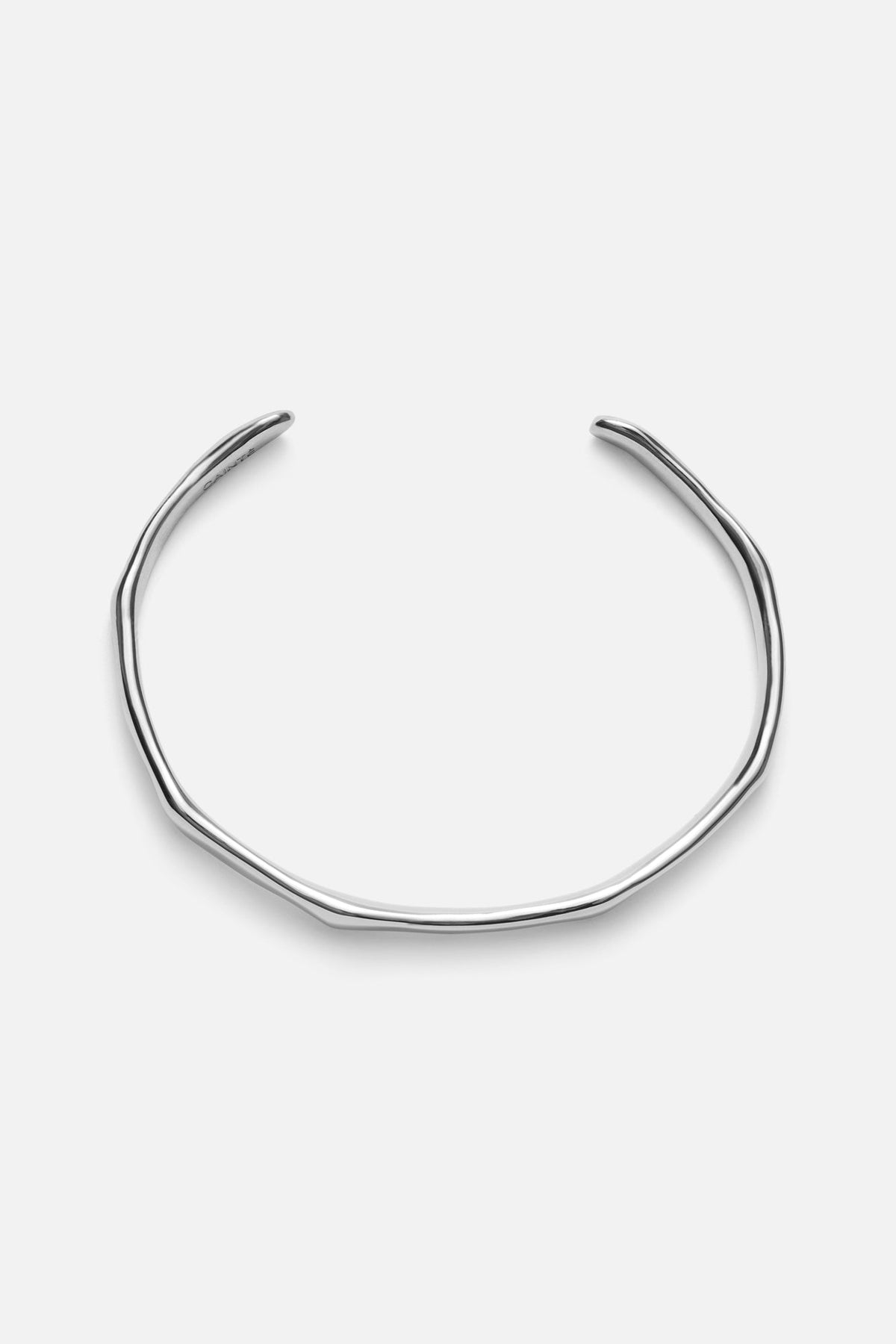 Silver-tone slim wavy cuff bracelet, front view on a light background
