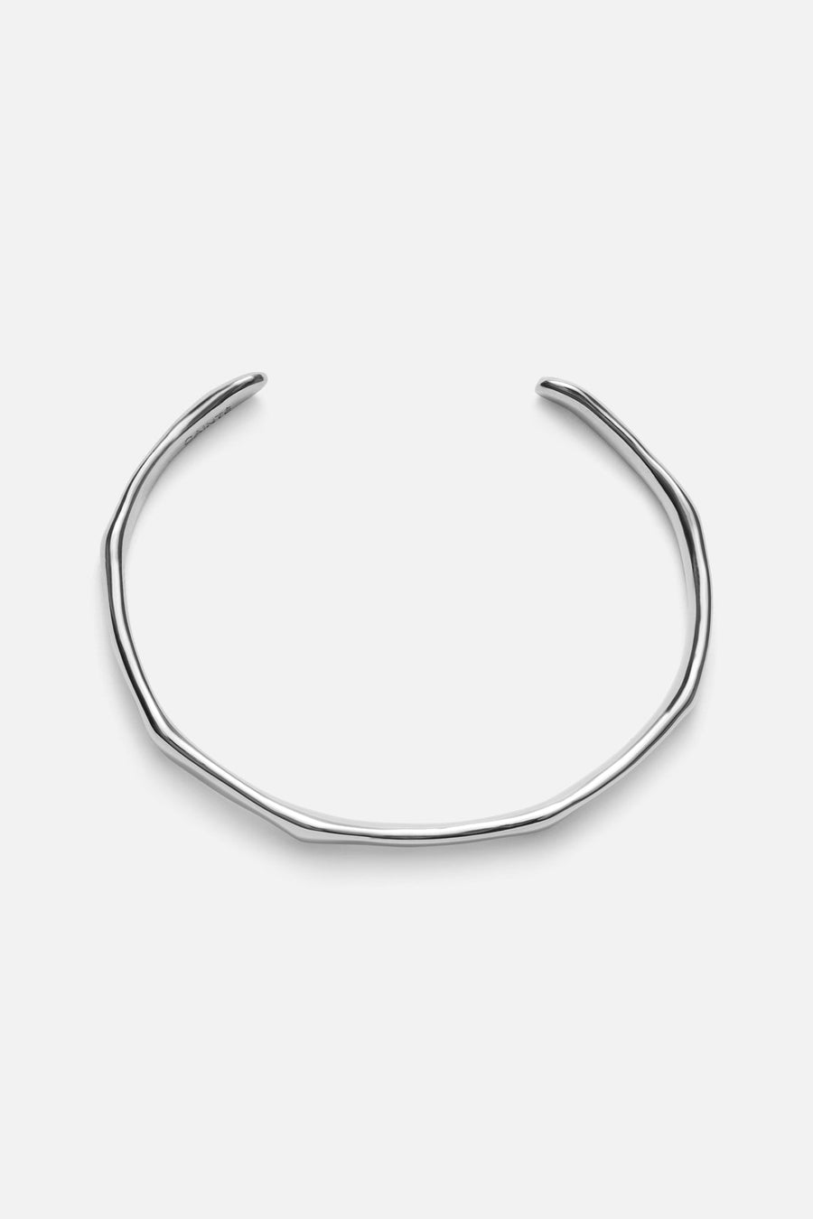Silver-tone slim wavy cuff bracelet, front view on a light background