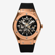 Rose gold-tone skeleton watch on a black rubber strap