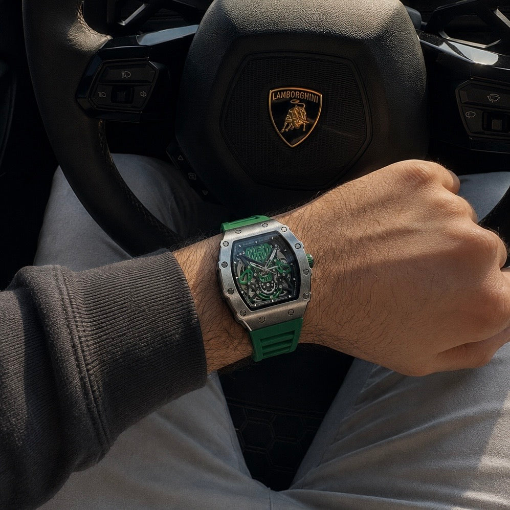 Green skeleton watch on the wrist near a steering wheel
