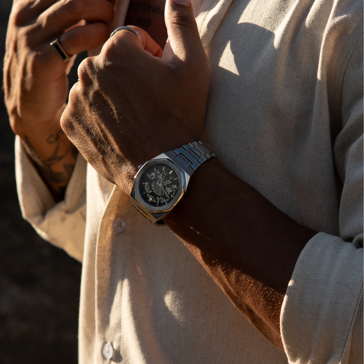 Octagonal watch worn with a light shirt