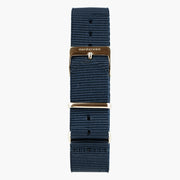 Navy nylon strap with a warm rose gold-tone buckle and keeper rings.