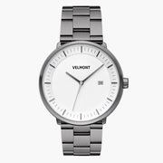 White-dial watch with a gunmetal case and bracelet, centered front view.