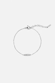 Silver-tone fine station bracelet, front view on a light background
