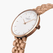 Angled view of the slim case, crown and five-row bracelet in rose gold tone.