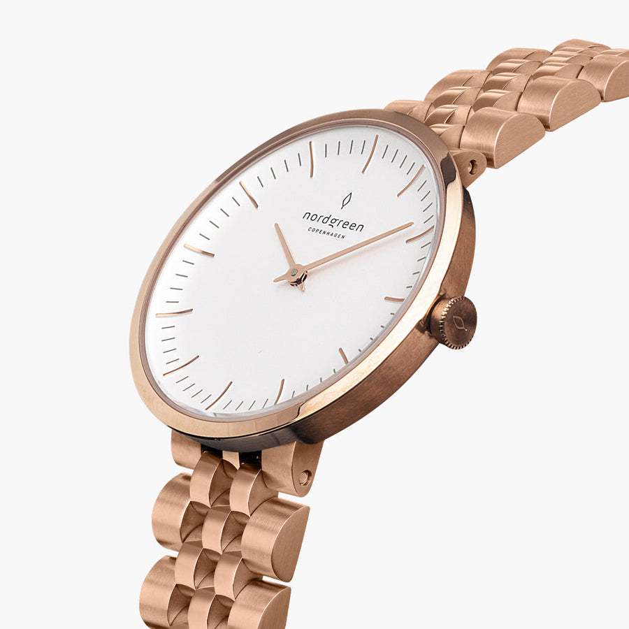 Angled view of the slim case, crown and five-row bracelet in rose gold tone.