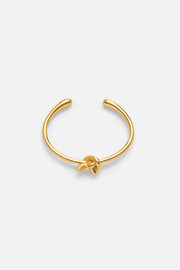 Gold-tone heart cuff bracelet, front view on a light background