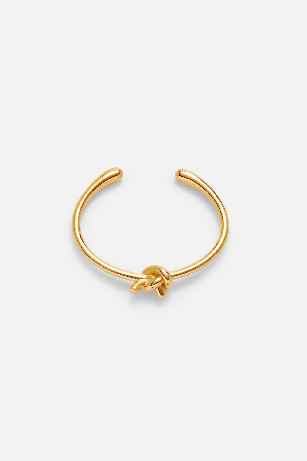 Gold-tone heart cuff bracelet, front view on a light background
