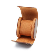Open brown watch roll with tan pillow