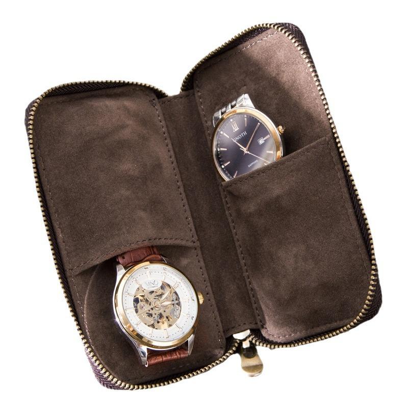 Open brown case with two watches in separate pockets