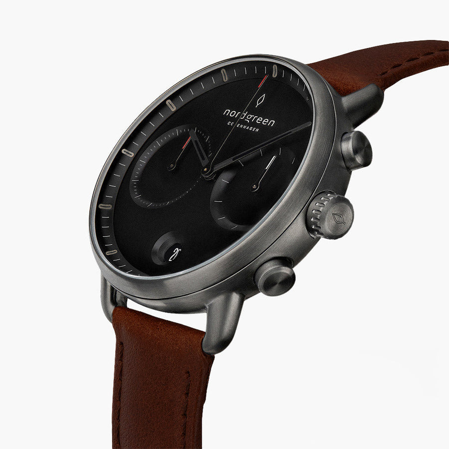 Angled view of the black dial with two subdials and gunmetal pushers.