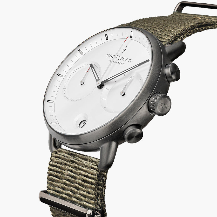 Angled view of the gunmetal case with pushers and an olive green band.