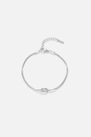 Silver-tone fine chain bracelet with a knot, front view on a light background