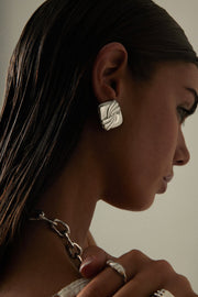 Model in profile wearing the square stud earring
