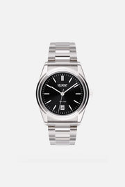 Front view of the round watch with black sunburst dial and date window