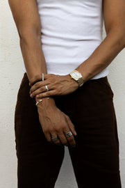 Man standing in a white T-shirt, watch on the wrist