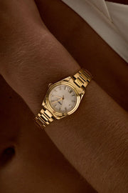 Close-up of the small round watch on a woman’s wrist