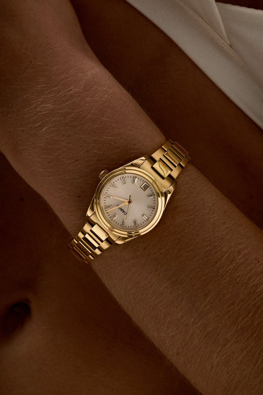 Close-up of the small round watch on a woman’s wrist