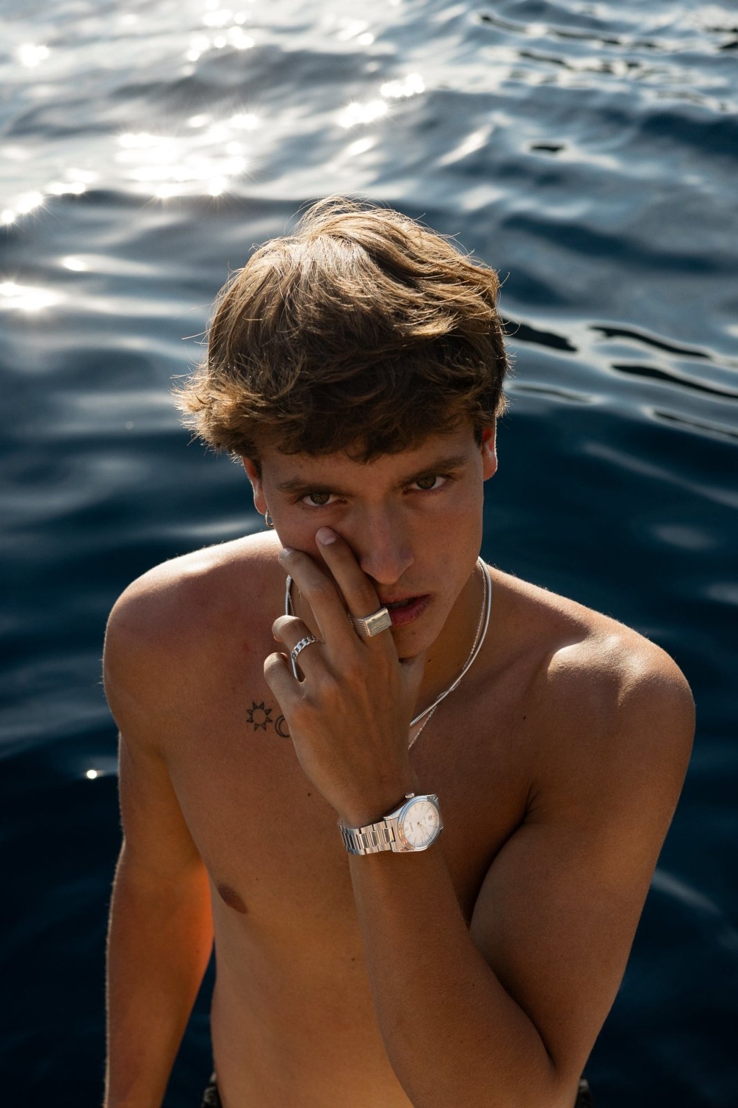 Man in the sea wearing the round watch