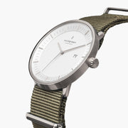Angled view of the white dial with its date window and silver-tone crown.