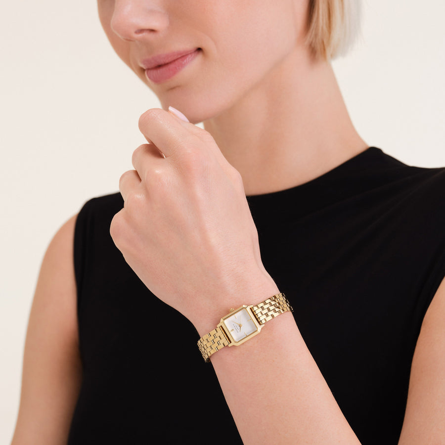 Small square watch worn at the chin