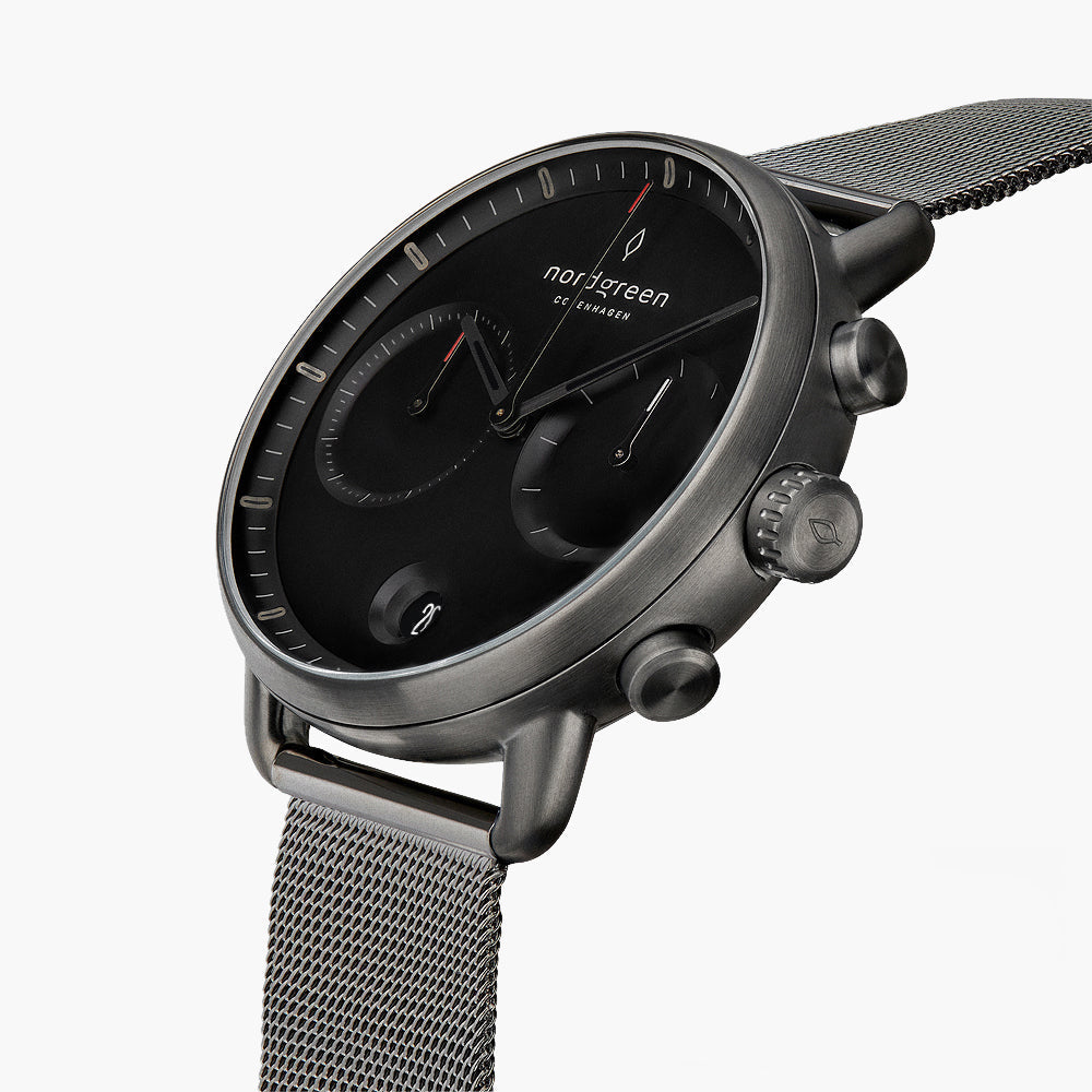Angled view of the black dial with two subdials, pushers and the gunmetal case.