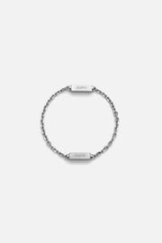 Silver-tone chain bracelet with two brushed bars, laid flat