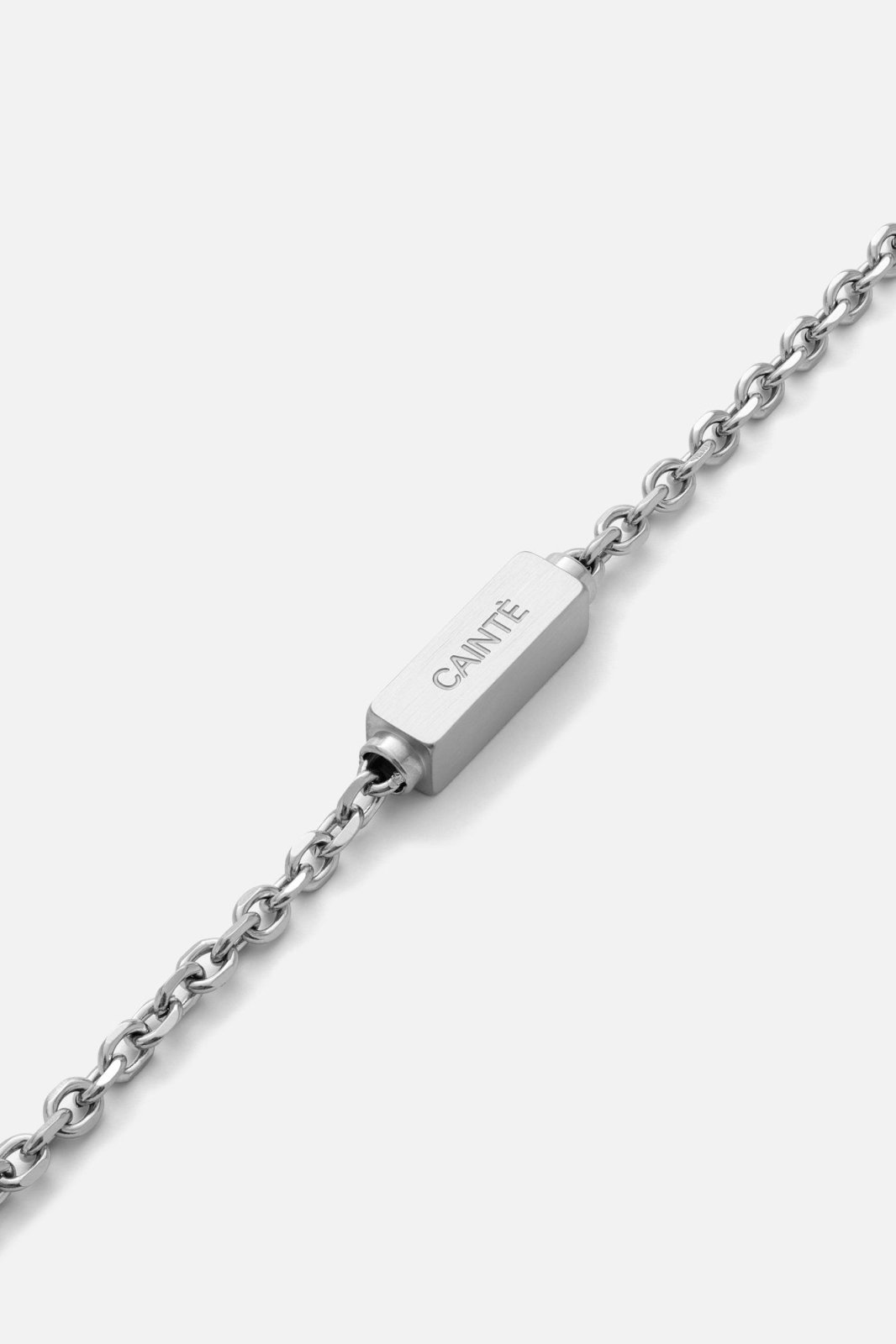 Close-up of a brushed rectangular bar on the silver-tone chain
