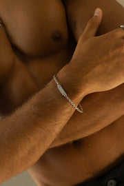 Silver-tone chain bracelet worn with arms folded