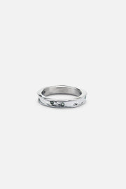 Textured band ring with small green stones, front view