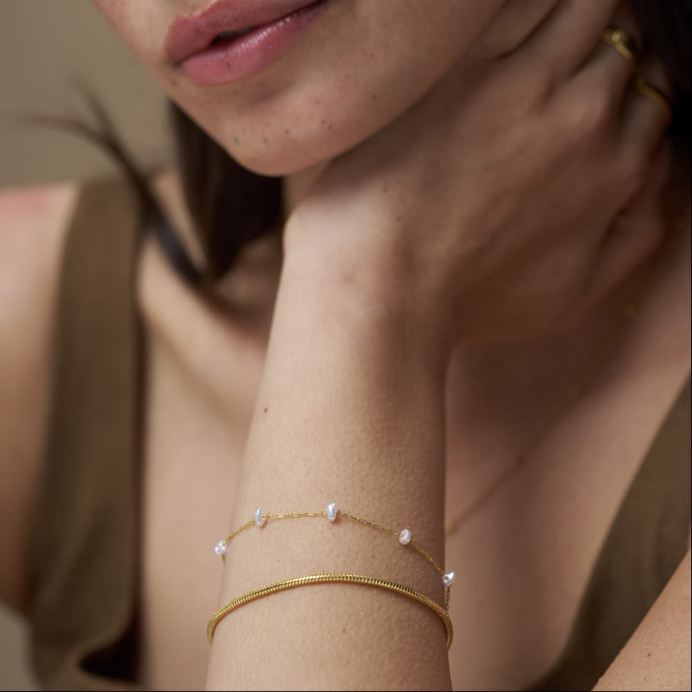 Two stacked bracelets worn on the wrist