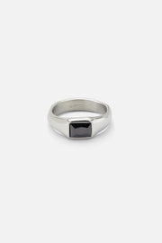 Silver-tone signet ring with a black rectangular stone, front view on a light background