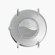 Silver-tone case back with an engraved circular motif.