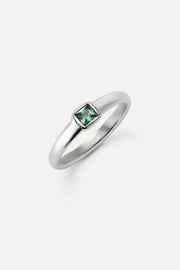 Green stone ring at an angle showing the bezel