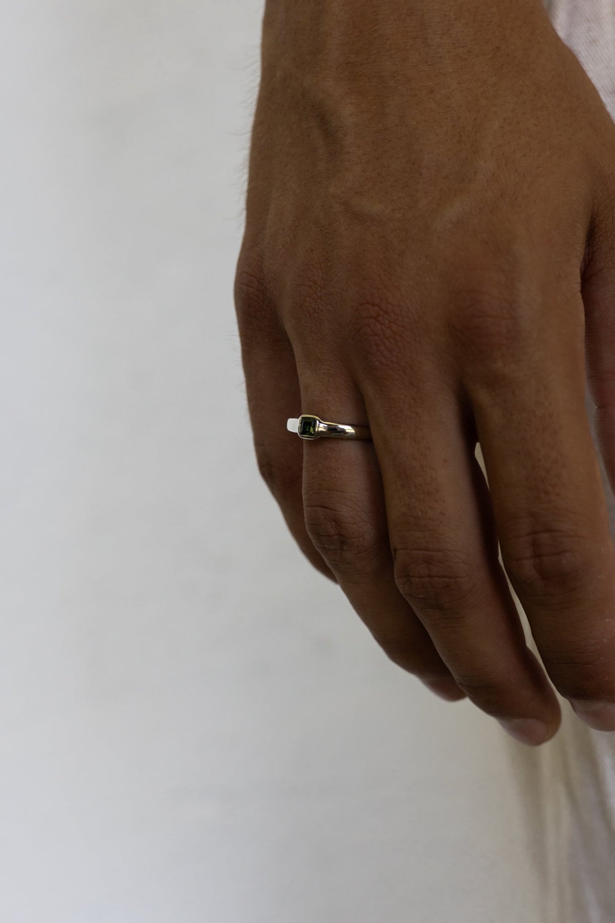 Close-up of the stone ring on the finger