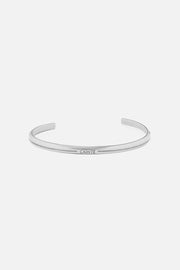 Silver-tone thin flat cuff, front view on a light background