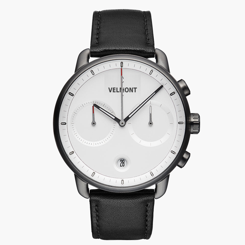 Chronograph-style watch with a white dial and gunmetal case on a black strap.