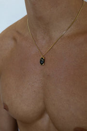 Gold-tone necklace with a black oval pendant, view 7 of 7