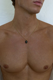 Gold-tone necklace with a black oval pendant, view 2 of 7