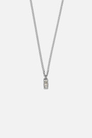 Silver-tone necklace with a small white inlay tag, front view on a light background