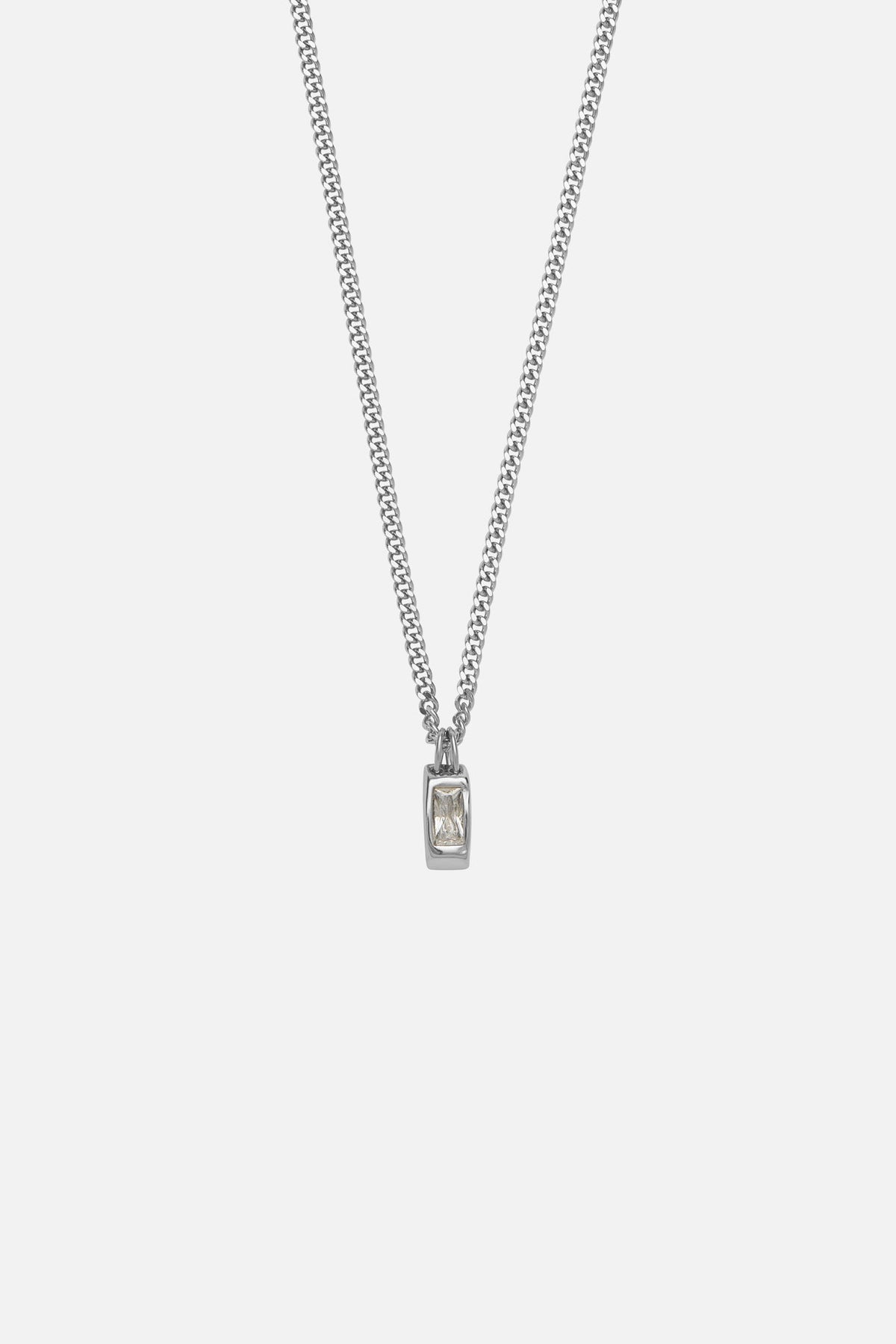 Silver-tone necklace with a small white inlay tag, front view on a light background