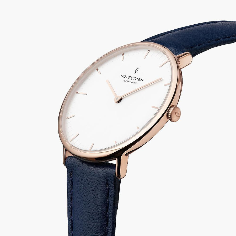 Angled view of the rose gold-tone case and crown with the navy strap.